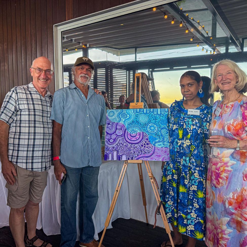Velda with board members posing for photo with her artwork at the Anglicare 25 year celebration